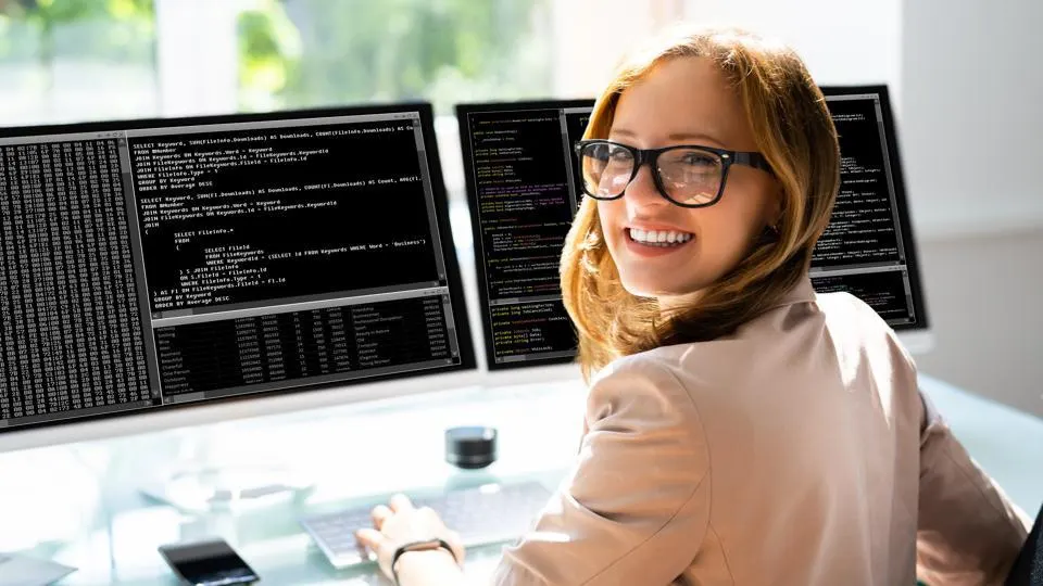 Image of a smiling web developer hard at work.